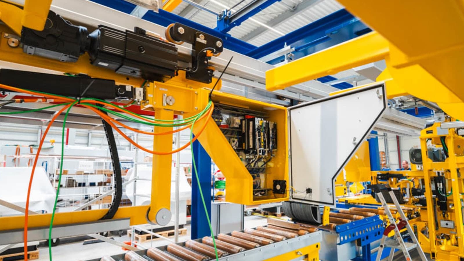 Unterschütz profile handling line in yellow livery being assembled in a machine hall.
